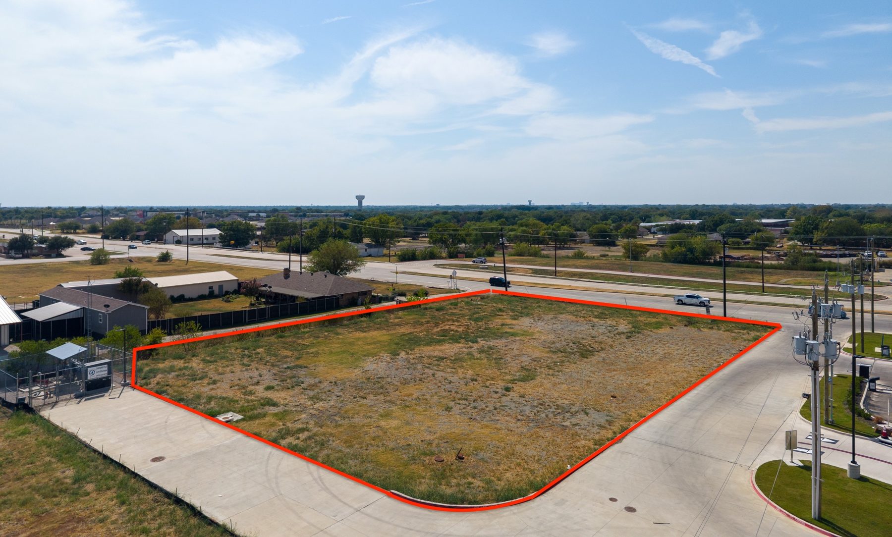 Low aerial of the Lot 4 pad and its paved shared drives, with an approximate lot outline