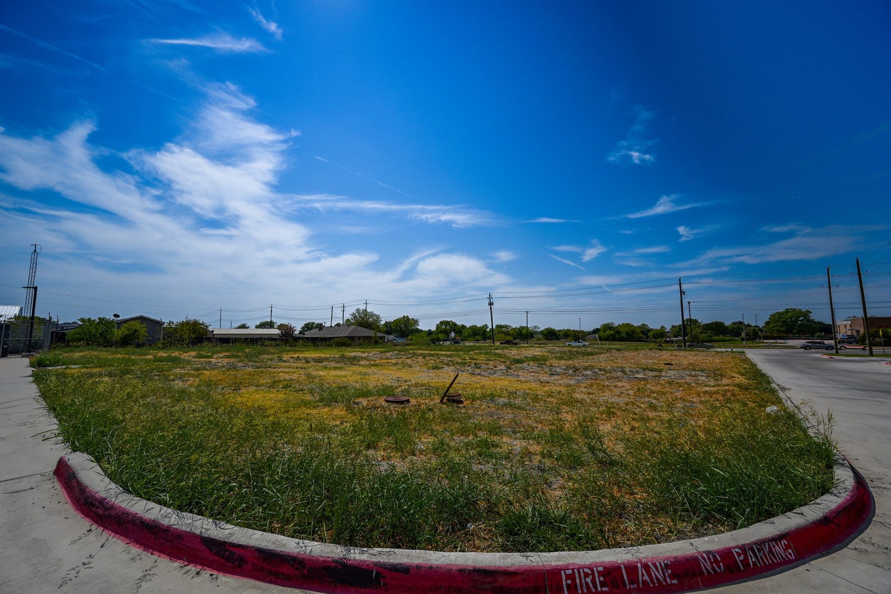 Ground-level view across the Lot 4 pad from the paved drive